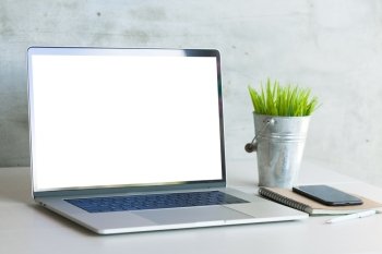 laptop computer on work desk showing white blank screen