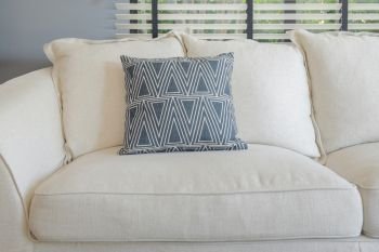 Close up sofa with teal pillows at center