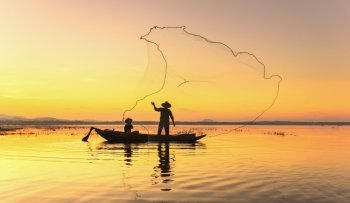 Fishermen fishing in the early morning golden light