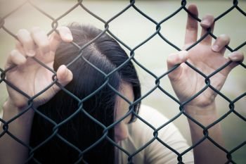 Depressed, trouble and solution. Hopeless women hand on chain-li. Depressed, trouble and solution. Hopeless women hand on chain-link fence.