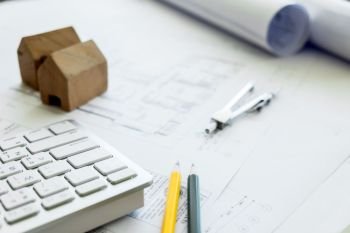 Construction equipment. Repair work. Drawings for building Architectural project, blueprint rolls and divider compass on table. Engineering tools concept. Copy space.