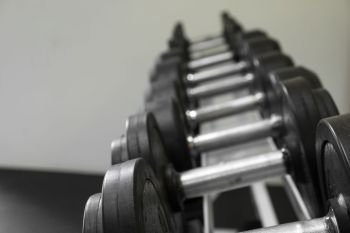 Dumb bells lined up in a fitness studio. picture is short focus.
