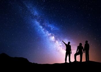Colorful Milky Way with silhouette of a standing man pointing finger in night starry sky and his parents. Silhouette of a family. Night landscape. Beautiful Universe, space background