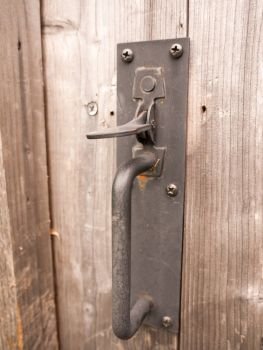 a metal lock to a garden gate outside locked