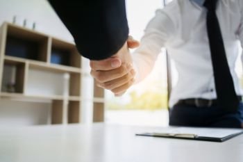 human resource recruiter handshaking with candidate