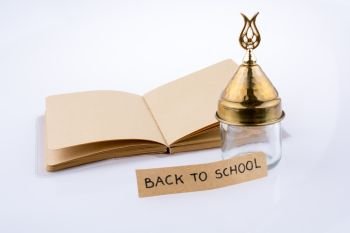Color pencil, glass bottle and back to school title on a notebook