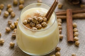 Boza or Bosa, traditional Turkish drink with roasted chickpeas and cinnamon on the table. top view