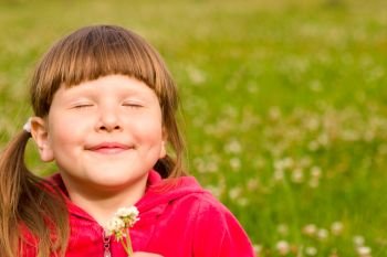 Happy girl smiling with closed eyes holding clower flowers