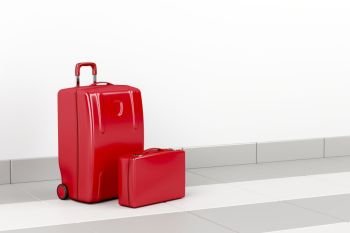 Red suitcase and briefcase at the airport