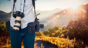 Photographer with beautiful landscape sunrise at mountain.