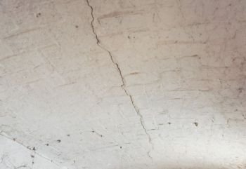 cracked vault ceiling. crack in a brick vault ceiling caused by excessive settling due to bad foundations or too much load or earthquake