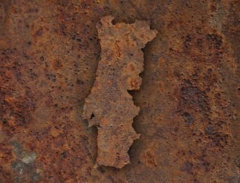 Map of Portugal on rusty metal