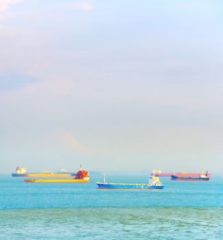 Industrial shipping tankers in Singapore harbor in the daytime