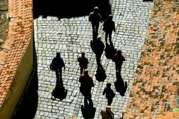 Aerial view of people walking along the cobblestone street of the Old City. Romania