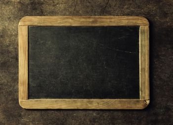 Blank chalkboard for your text. Top view over rustic table with copy space