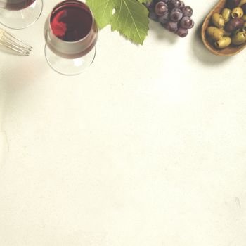 Wine appetizers set: French cheese selection, grapes and walnuts on concrete background. Top view, copyspace
