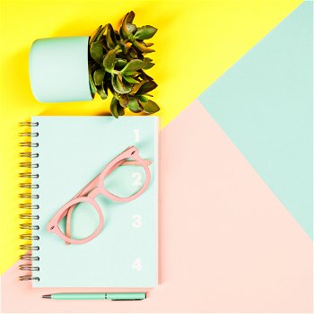 Creative flat lay with plants, glasses, notebook diary and pen on pastel colors background. Creative flat lay on pastel colors background. Creative flat lay on pastel colors background