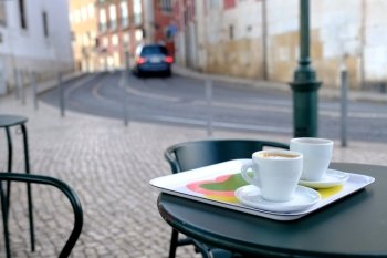 Cup of coffee over old european cityscape