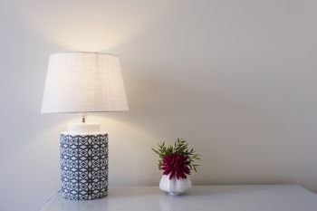 Lamp and flowers on a table. Lamp and flowers on a wooden table