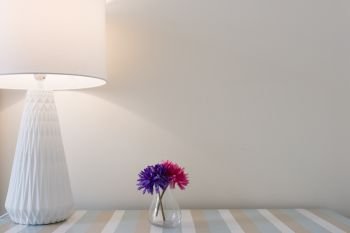 Lamp and flowers on a table. Lamp and flowers on a wooden table