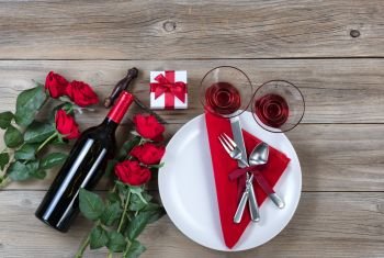 Valentine  Dinner table setting on rustic wood in flat lay view