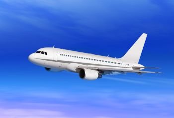 flying white passenger plane in blue sky
