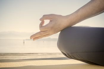 An image of a hand in a meditation pose