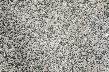 Mixed cement and small stone gravel mosaic slab surface closeup as background