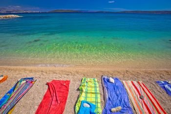 Towels on idyllic beach in Kastela bay, Dalmatia region of Croatia