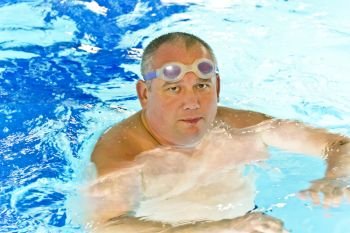 Portrait of big fat man in swimming pool water