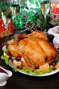 Delicate baked chicken   with an appetizing crust with a citrus garnish on the Christmas table