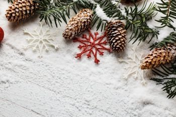 Snowy christmas background with fir branch and pine cones.. Snowy christmas background with fir branch and pine cones