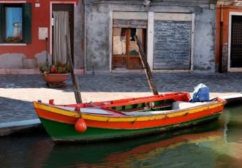 Old motorboat on the street in Burano, Italy. Motorboat in Burano