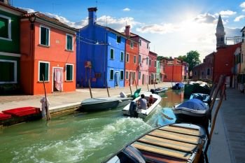 View on colored houses and water canal in the street of Burano, Italy