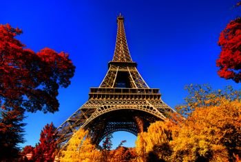 Eiffel Tower in autumn park with colorful trees, Paris