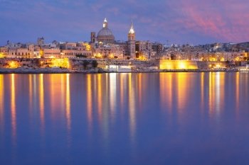 Valletta Skyline from Sliema at night, Malta. Valletta Skyline from Sliema with church of Our Lady of Mount Carmel and St. Paul’s Anglican Pro-Cathedral during evening blue hour, Valletta, Capital city of Malta