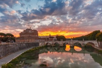 Saint Angel castle and bridge at sunrise, Rome. Saint Angel castle and bridge with mirror reflection in Tiber River during gorgeous dawn in Rome, Italy.