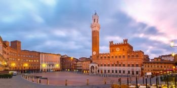 Piazza del Campo at beautiful sunrise, Siena Italy. Mangia Tower or Torre del Mangia towering above of the Palazzo Pubblico on Piazza del Campo in medieval city of Siena at beautiful sunrise, Tuscany, Italy