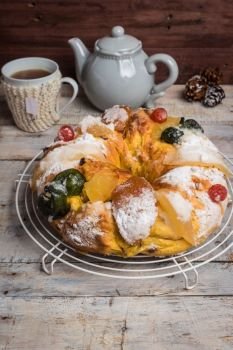 Merry Christmas cake with nuts - Bolo Rei is a traditional Xmas cake with fruits raisins nut and icing on wooden table.