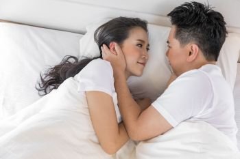 Young loving couple in the bed. Modern lifestyle concept