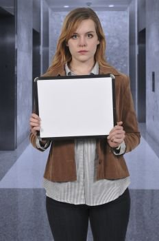 Beautiful young woman holding up a blank dry erase sign