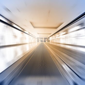 Escalator in motion - abstract business and architectural background