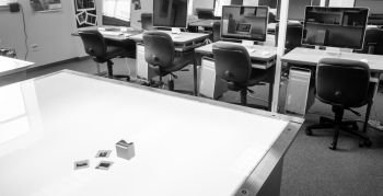 Monochrome representation of a college graphic design classroom with light table and slides