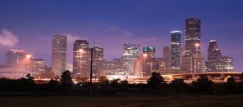 Deep blue sky after dusk as lights illumiinate the buildings of the inner city at Houston Texas USA North America