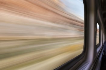 blurred abstract of canyon landscape seen from a  train window in motion - travel concept