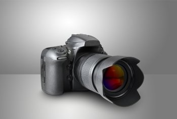 Digital photo camera on gray background