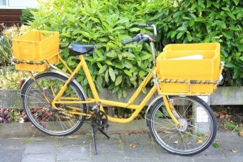 A yellow bicycle, used to deliver the mail