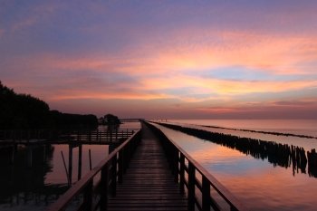 wooden jetty on seaside with twilight sky background