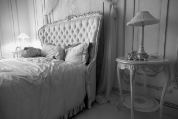Black and white photo of luxurious bedroom interior at hotel