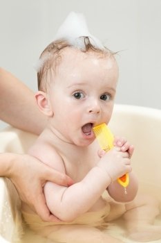 Portrait of cute baby boy singing while having bath time